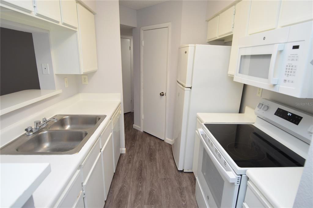 8641 Fancy Finch Drive, Unit 103 Tampa, FL 33614 - Photo 7 of 92 a kitchen with a refrigerator sink and stove
