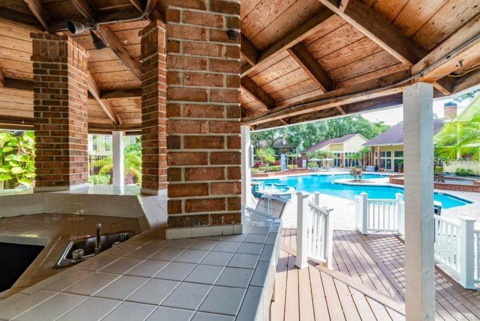 8641 Fancy Finch Drive, Unit 103 Tampa, FL 33614 - Photo 83 of 92 a view of a room with wooden floor and outdoor space