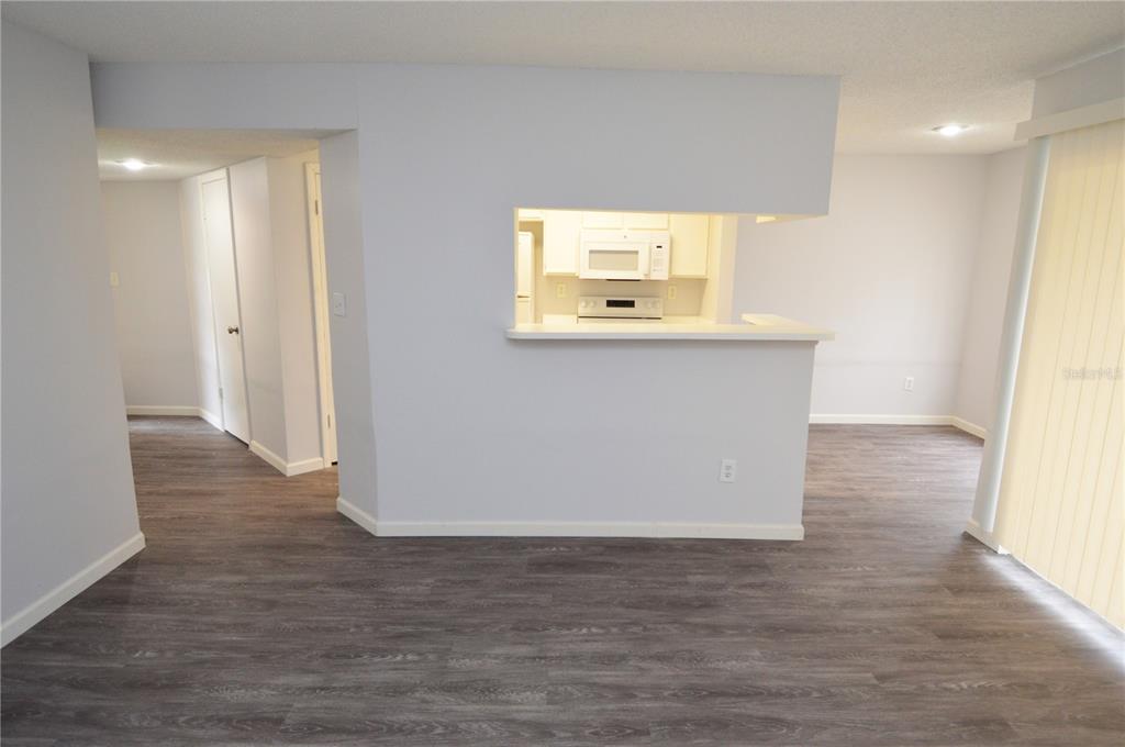 8641 Fancy Finch Drive, Unit 103 Tampa, FL 33614 - Photo 9 of 92 a view of an empty room with wooden floor and a window