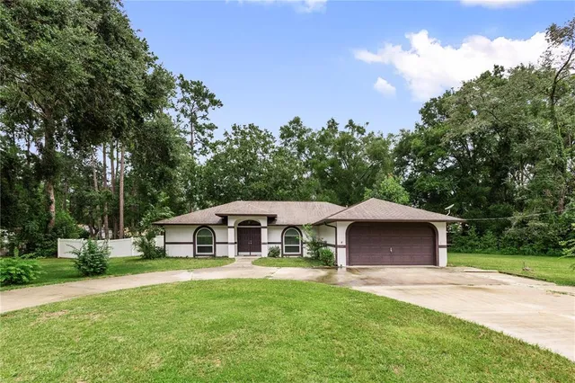 a front view of a house with yard porch and green space