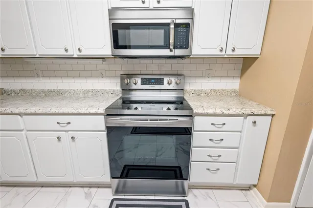 a stove top oven sitting inside of a kitchen