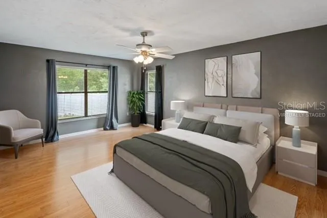 a spacious bedroom with a large bed and a chandelier