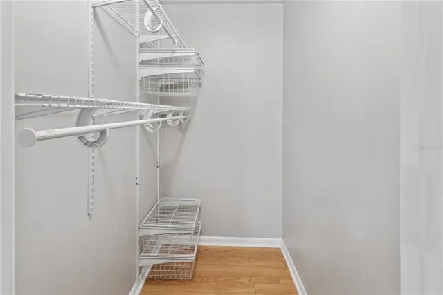 a bathroom with a granite countertop bathtub shower sink vanity and toilet