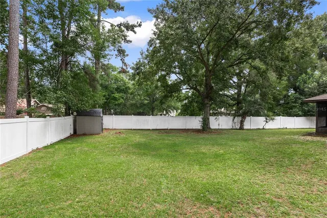 a view of a backyard with large trees