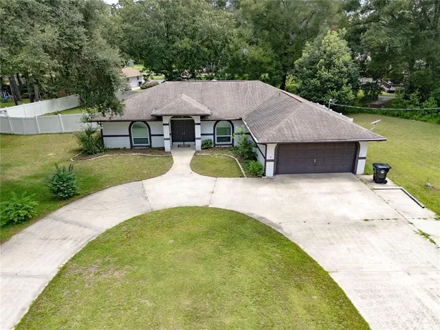 an aerial view of a house with swimming pool and patio