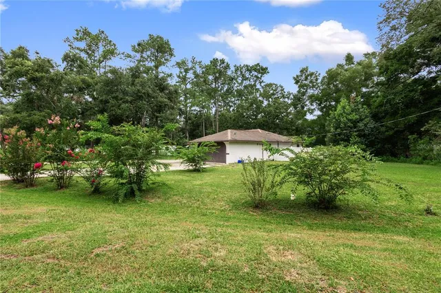 an aerial view of a house with swimming pool and garden