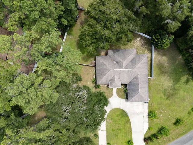 an aerial view of residential house with outdoor space and swimming pool