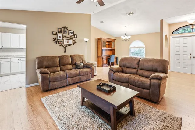 a living room with furniture a rug and a window