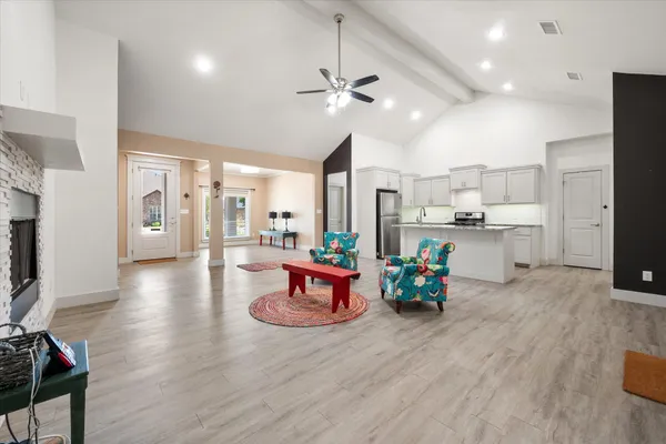 a kitchen with stainless steel appliances granite countertop a refrigerator and a sink