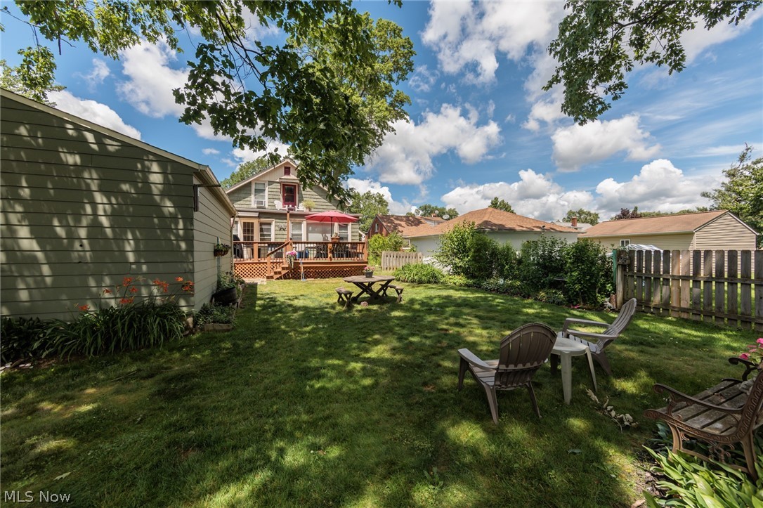 5364 Summit Road Lyndhurst, OH 44124 - Photo 32 of 42 Expansive backyard featuring a manicured lawn, a wooden privacy fence, and mature trees providing natural shade
