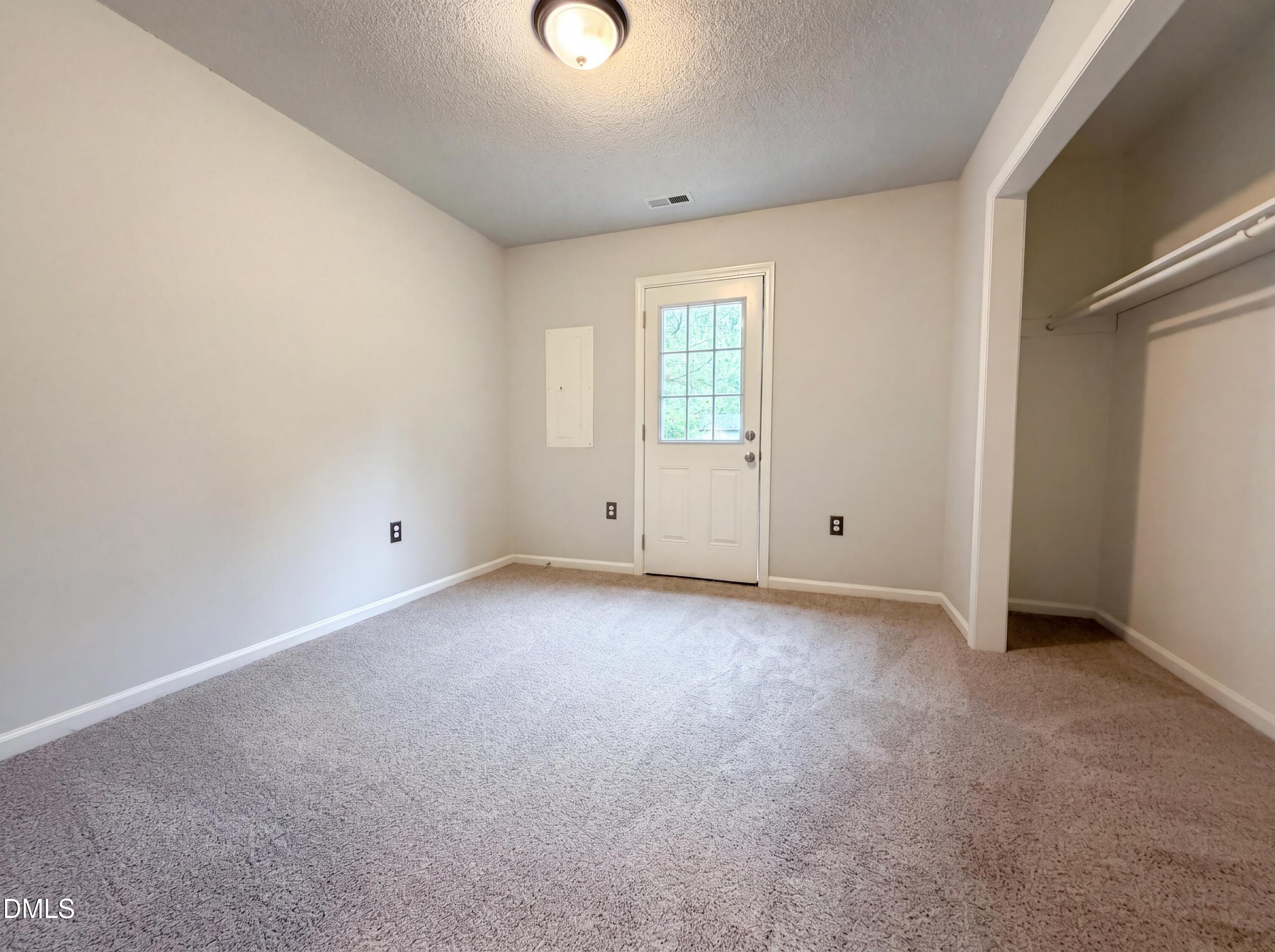 4894 Elevation Road, Unit C Benson, NC 27504 - Photo 13 of 24 an empty room with windows