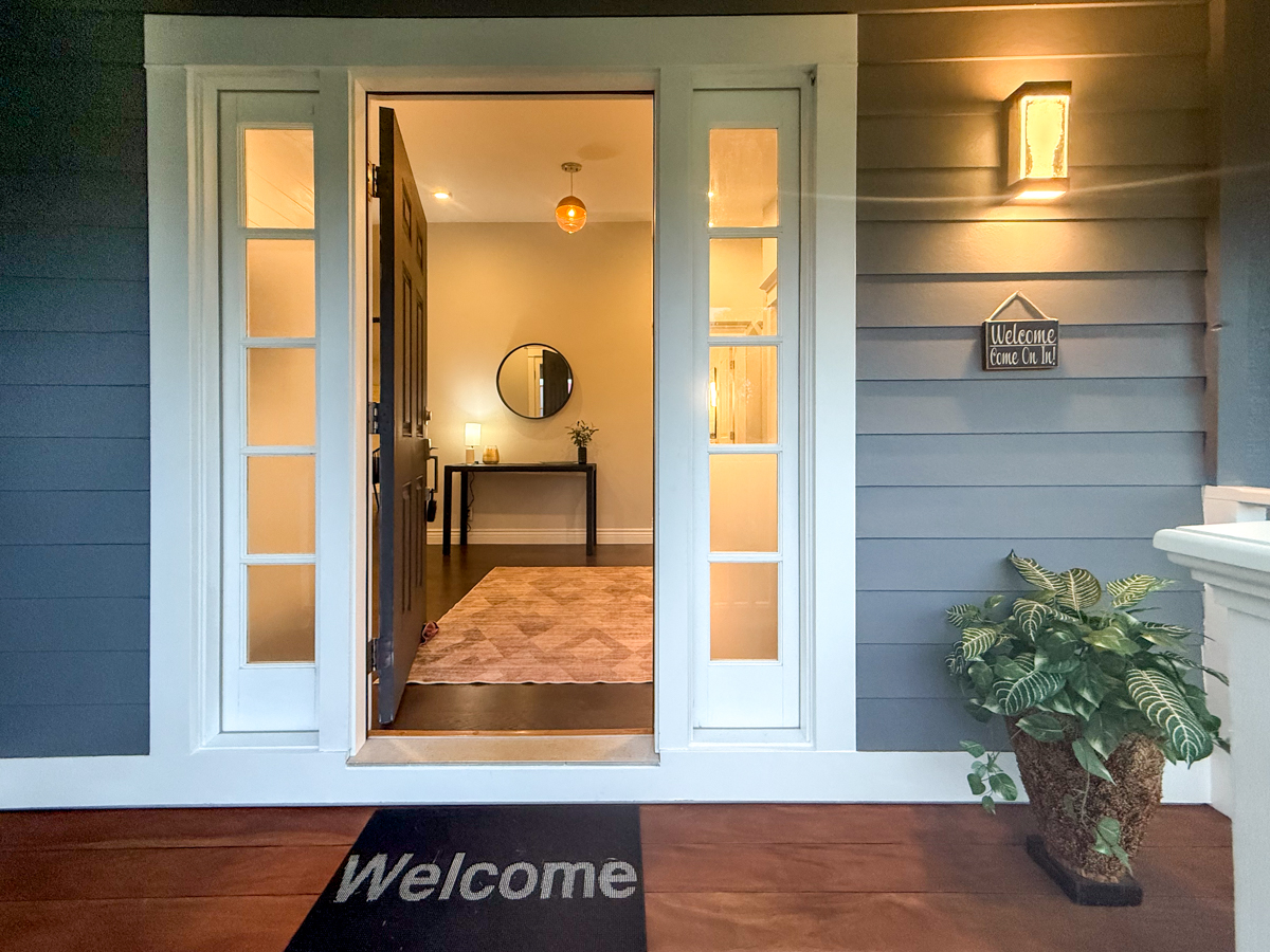 56 Nanea Street Hilo, HI 96720 - Photo 1 of 29 a potted plant sitting on a wooden table next to a window