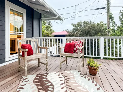 a view of deck with chairs and wooden floor