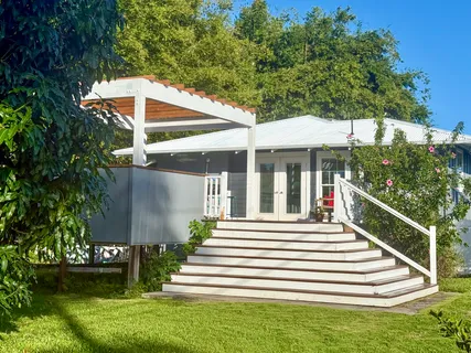 a view of a house with a yard and sitting area