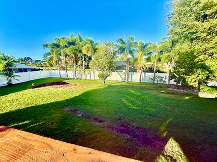 a view of a garden with a building in the background