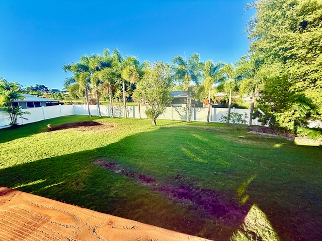 56 Nanea Street Hilo, HI 96720 - Photo 28 of 29 a view of a garden with a building in the background