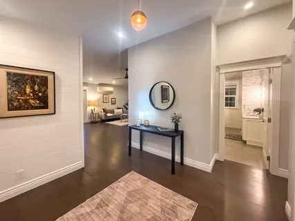 a living room with furniture and a wooden floor