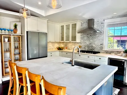 a kitchen with stainless steel appliances granite countertop a sink refrigerator and cabinets
