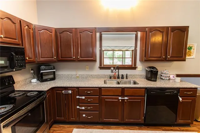 a view of a living room and kitchen with wooden floor