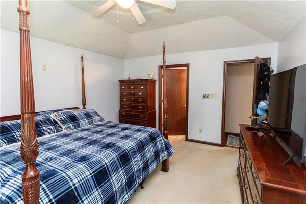 a bedroom with a bed and flat screen tv