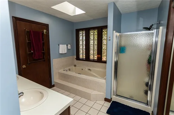 a bathroom with a bathtub and window