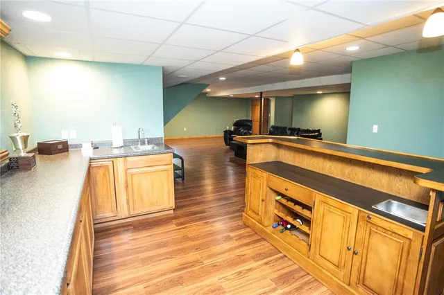 a kitchen with a sink and wooden floor