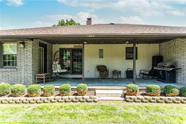 a front view of a house with swimming pool and porch