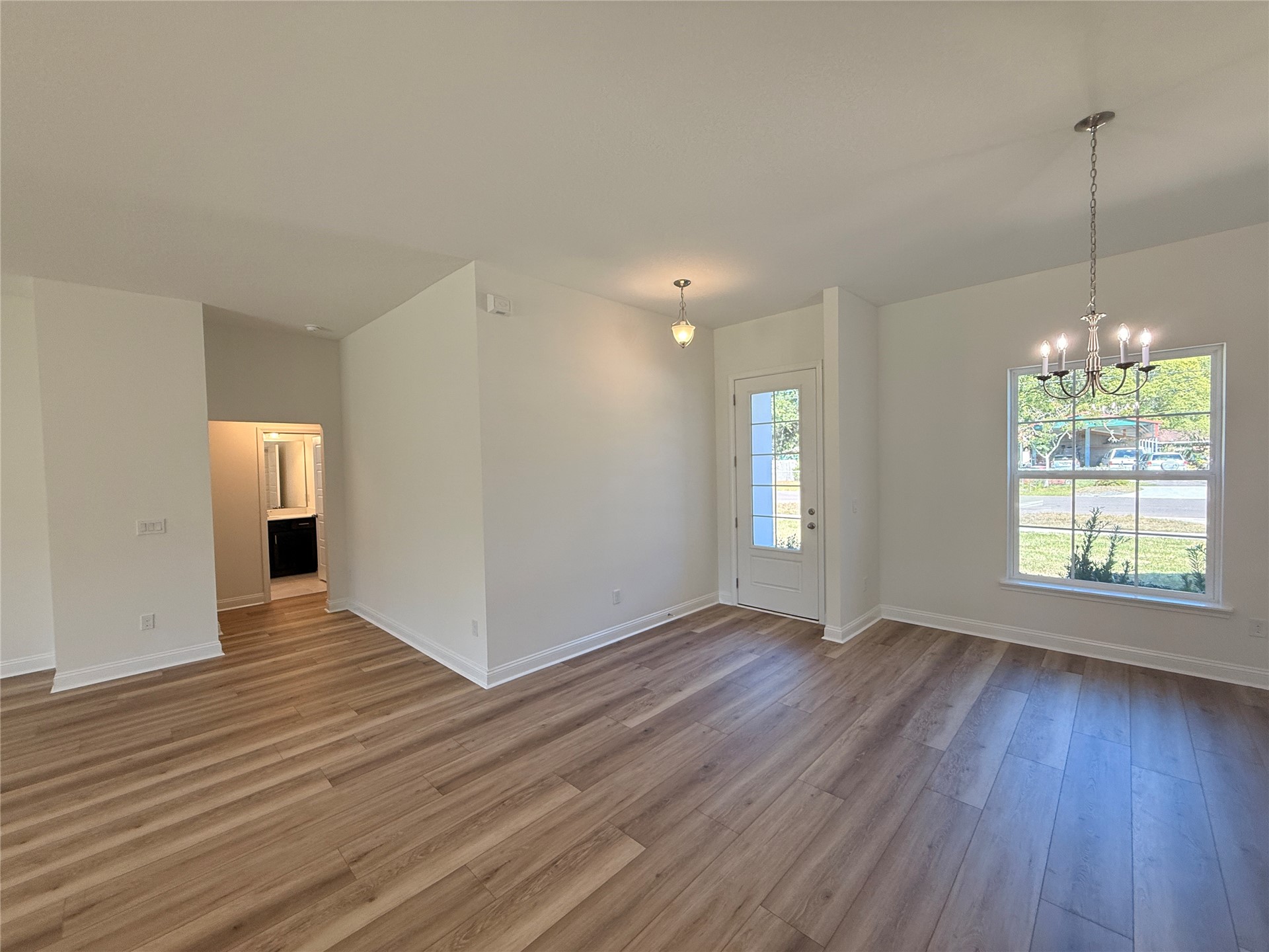 96076 Pirates Bluff Road Yulee, FL 32097 - Photo 9 of 22 a view of an empty room with wooden floor and a window