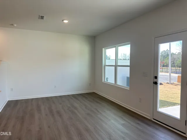 a view of a kitchen with a sink and wooden floor