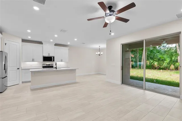 a view of kitchen with refrigerator stove and wooden floor