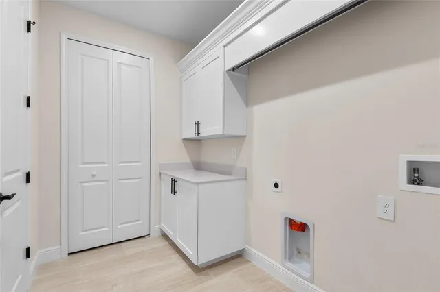 a view of storage and utility room with a door