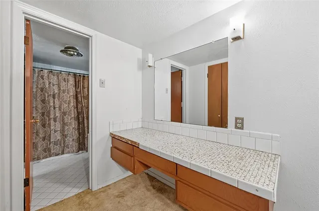 a bathroom with a tub and shower