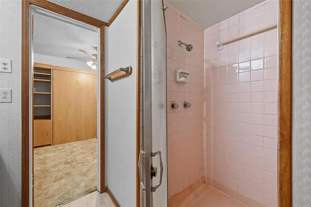 a bathroom with a shower and a glass door