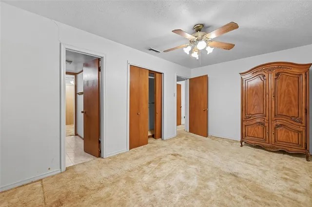 a view of a livingroom with a chandelier fan
