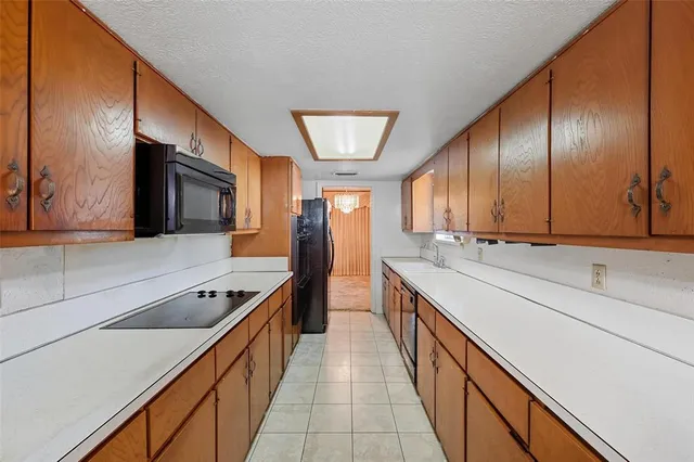 a kitchen with stainless steel appliances sink stove microwave and cabinets