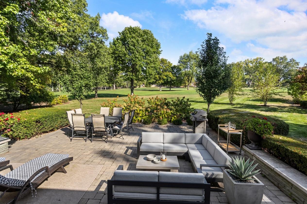 7 Greencroft Drive Champaign, IL 61821 - Photo 34 of 44 a view of a patio with lawn chairs potted plants and a big yard