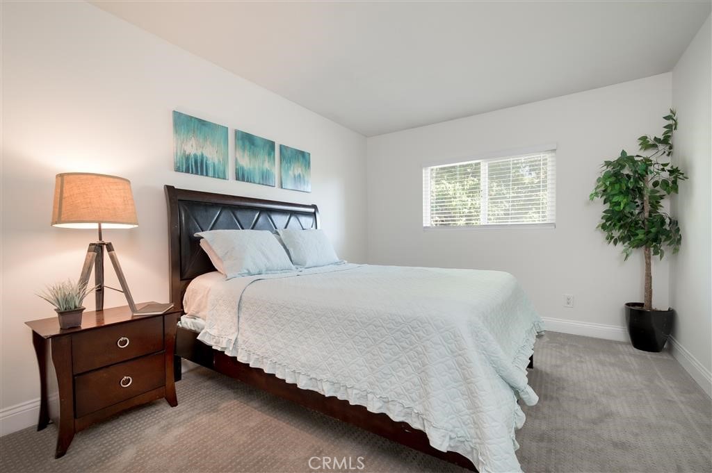 12805-18 Mapleview Street Lakeside, CA 92040 - Photo 21 of 28 a bedroom with a bed and a potted plant