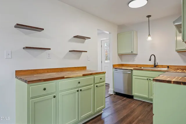 a kitchen with sink cabinets and wooden floor