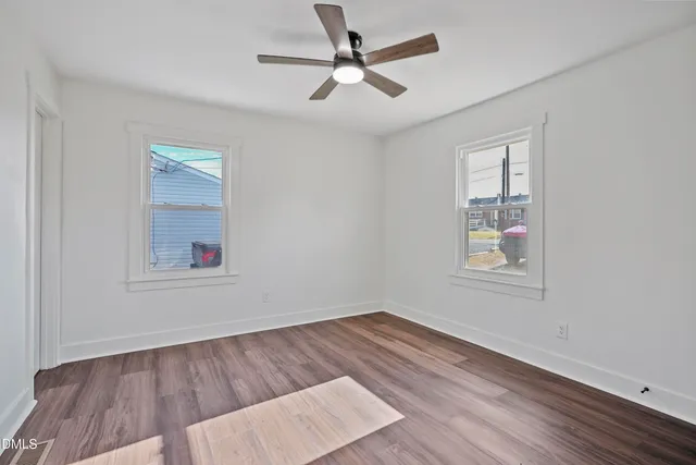 wooden floor in an empty room with a window