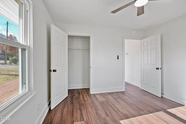 wooden floor in an empty room with a window