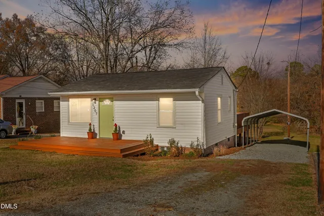 a backyard of a house with table and chairs