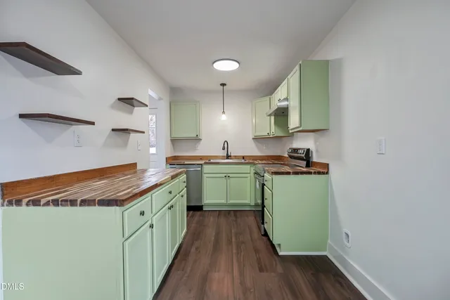 a kitchen with a sink and wooden cabinets