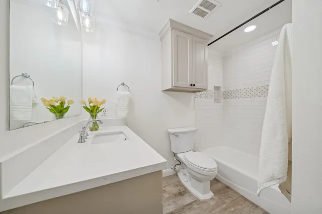 a bedroom with a bed and a potted plant