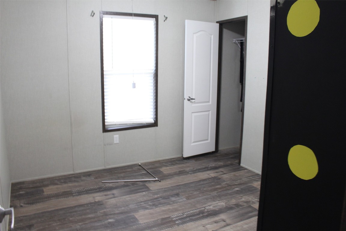 555 Beaver Run Grapeland, TX 75844 - Photo 12 of 21 a view of a room with wooden floor and glass door