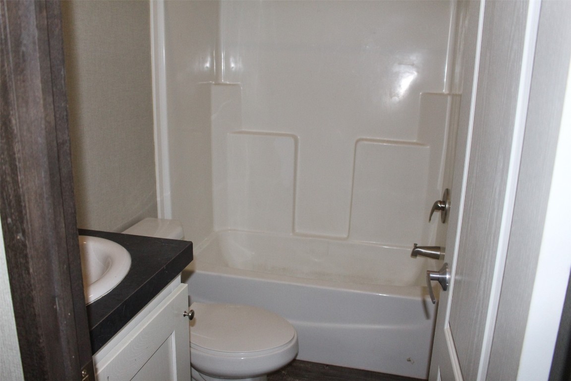 555 Beaver Run Grapeland, TX 75844 - Photo 14 of 21 a bathroom with a granite countertop sink toilet and shower
