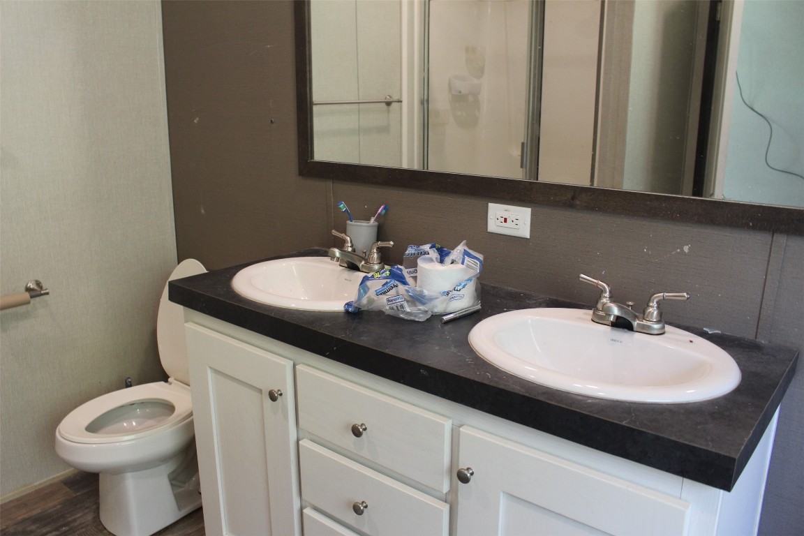 555 Beaver Run Grapeland, TX 75844 - Photo 20 of 21 a bathroom with a sink and a toilet