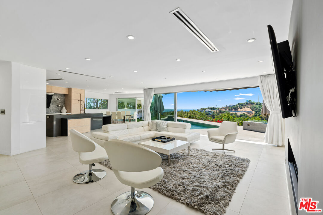 849 Glenmere Way Los Angeles, CA 90049 - Photo 11 of 51 a living room with dining table a rug and white appliances