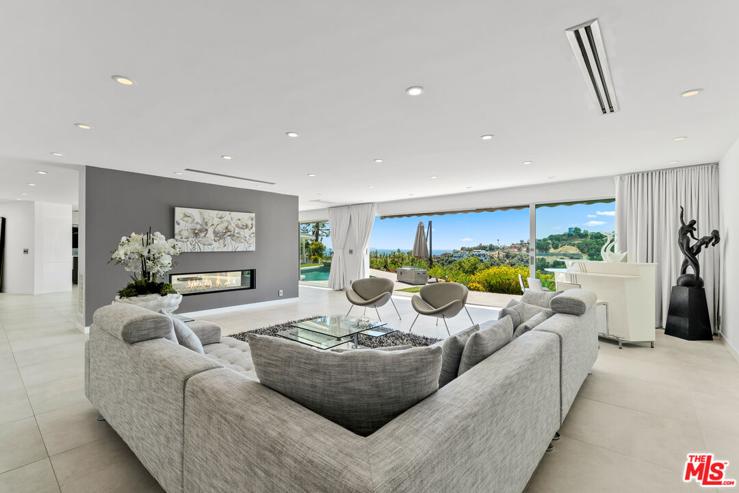 849 Glenmere Way Los Angeles, CA 90049 - Photo 13 of 51 a living room with furniture potted plant and a large window