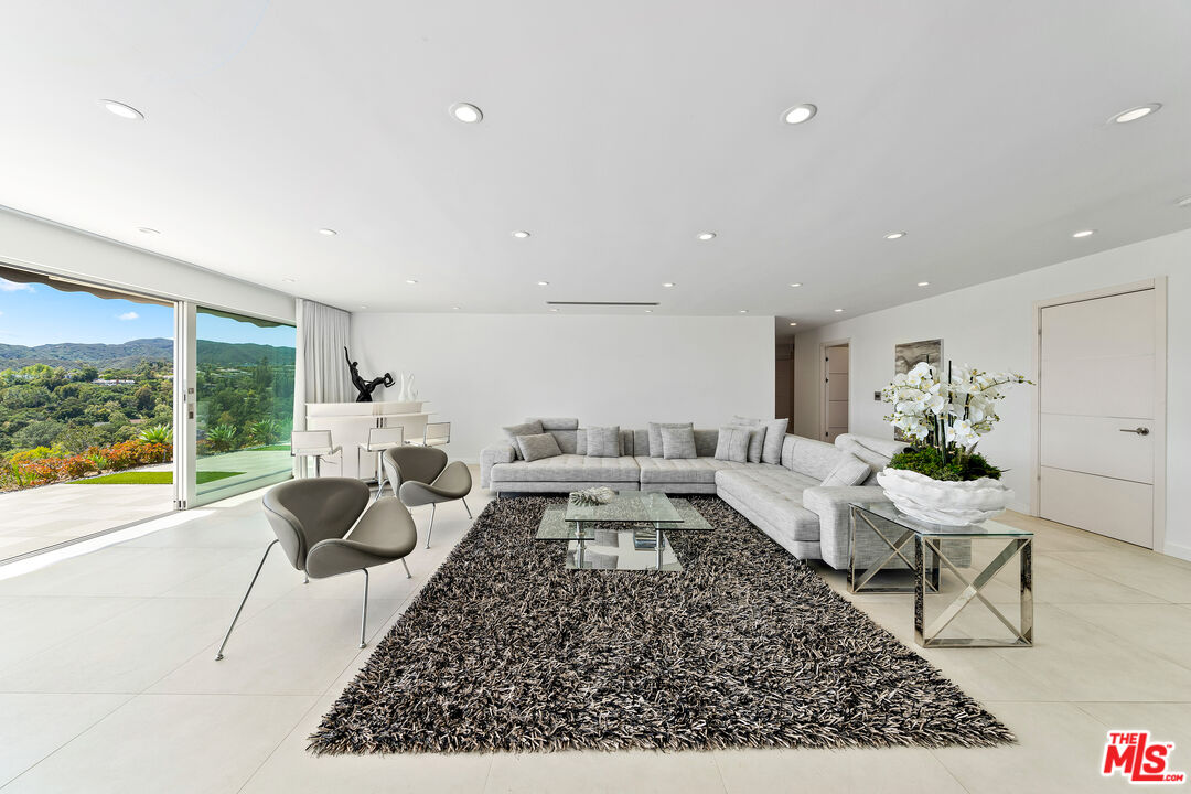 849 Glenmere Way Los Angeles, CA 90049 - Photo 15 of 51 a living room with furniture and a large window