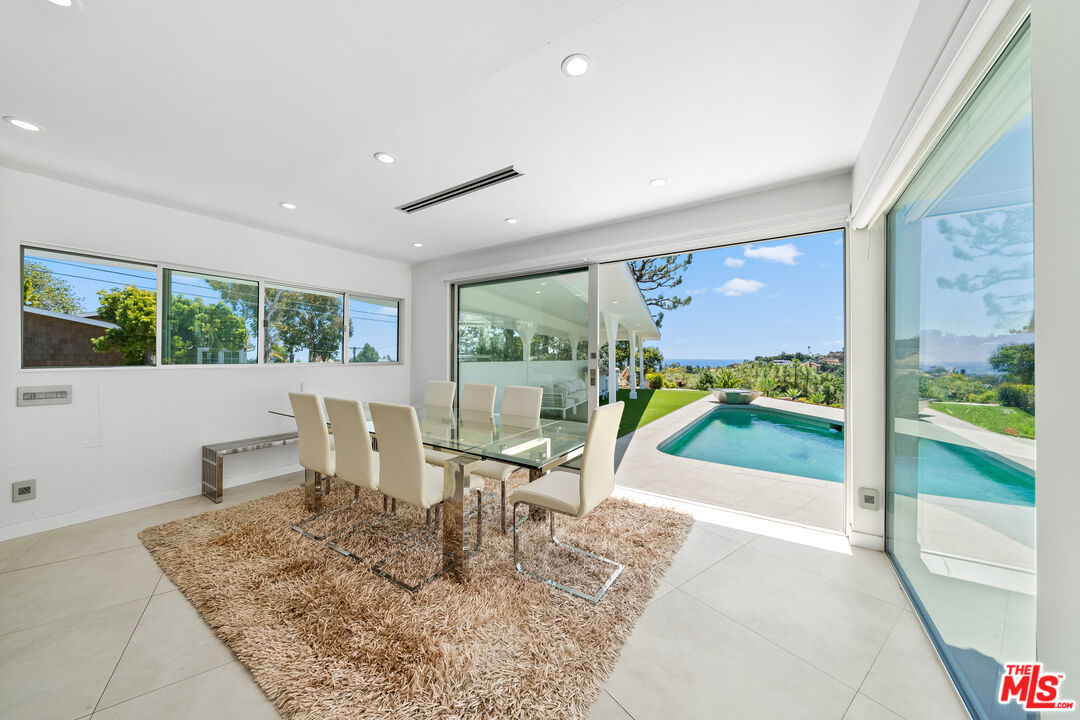 849 Glenmere Way Los Angeles, CA 90049 - Photo 20 of 51 a view of a dining room with furniture water view and wooden floor